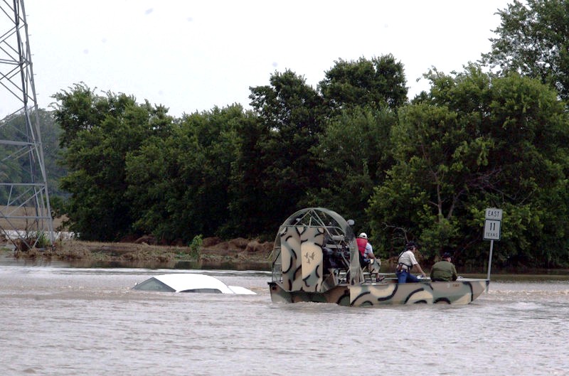 An airboat searches a car that was swept off State Highway 11 in Sherman, Texas photo: Chris Jennings / Herald Democrat