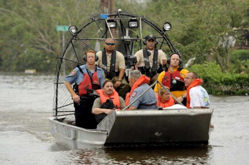 Rescue workers in an airboat evacuate local citizens from their flooded homes in the bayfront area of Galveston, Texas, USA, 13 September, 2008 following the landfall of Hurricane Ike. Galveston took a direct hit from Ike, which caused extensive flooding in the area.&nbsp;photo: EPA/Bob Pearson