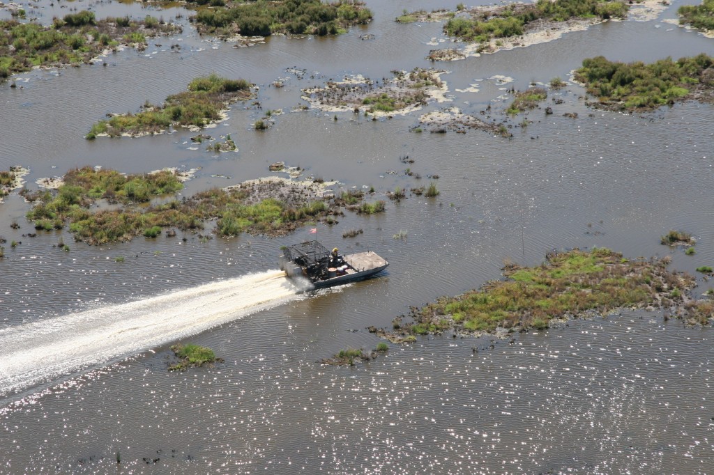 Airboat hauls away 55 gallon drums recovered form the debris fields at Sabine NWR