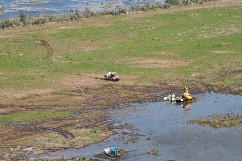 Airboats, marsh masters and specialized rigs gather debris left from Hurricane Rita at Sabine NWR