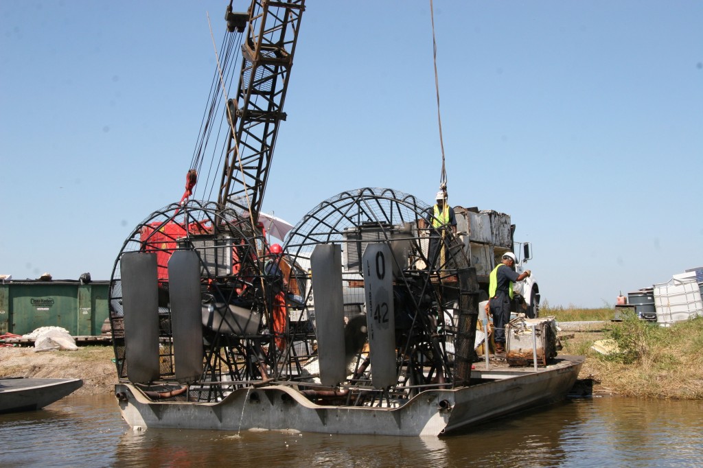 Workers unload debris recovered by airboats