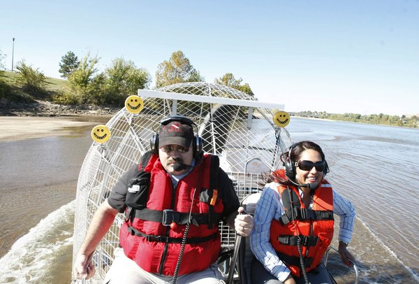 Deputy David Long (left) takes Daniela Medrano, the public relations officer for the Tulsa County Sheriff's Office, along for a test ride on the Arkansas River in the department's new air boat Wednesday. CORY YOUNG / Tulsa World